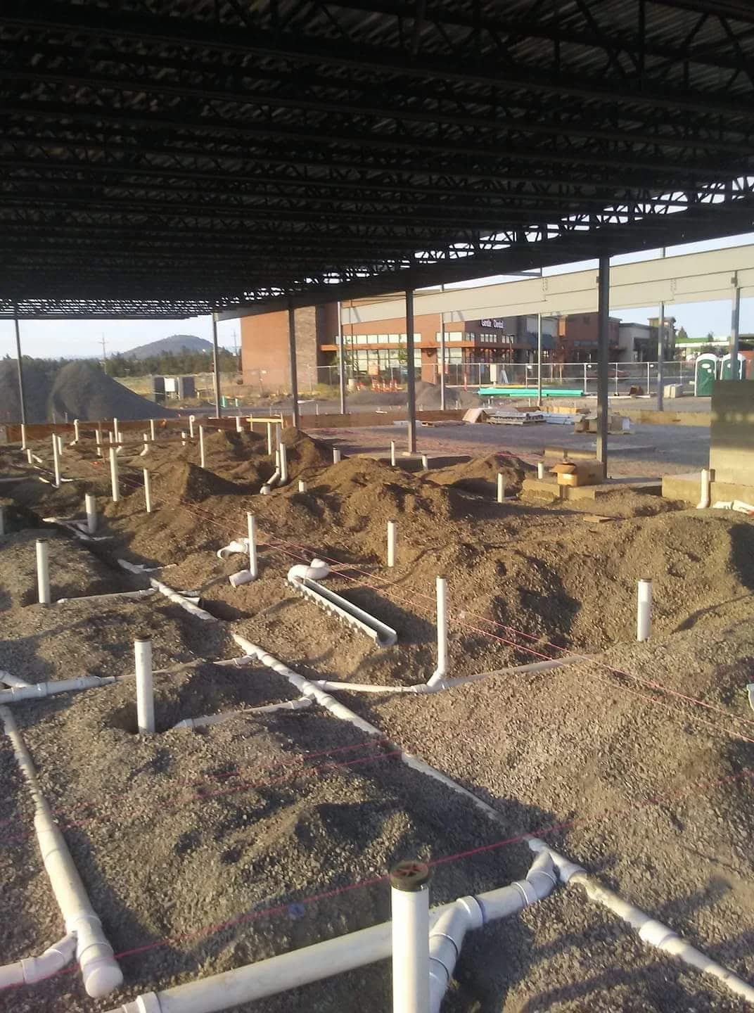 Plumbing lines installed below ground at a building under construction