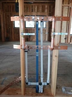Water supply lines and shower valves installed within exposed wall framing
